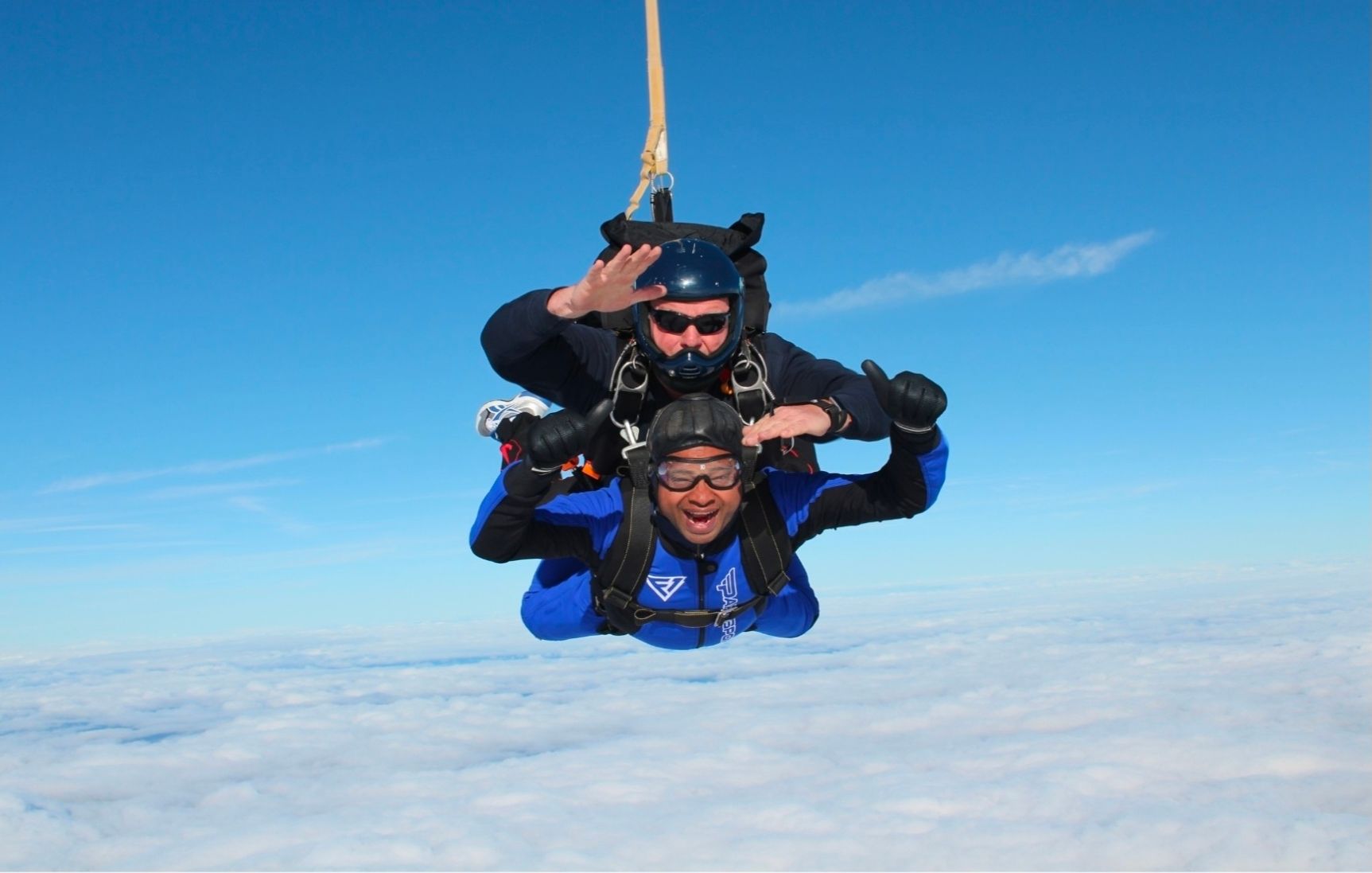 A Surrey Mark member on a tandem skydive above the clouds